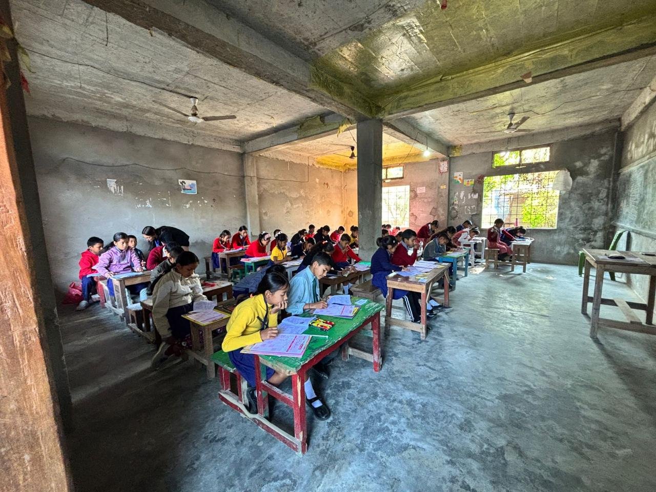 Students taking exam in a village school